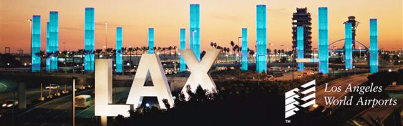 photo of LAX pylons illuminated in teal