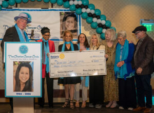 Rotary of Woodland Hills presents $3,000 check with Sandy Rosenholz, Rabia Dahal, Paulinda, Bryna Hornstein, Shelley Stark, Lois Koch, Eva Hainer, Jerry Ward