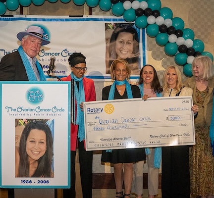 Rotary of Woodland Hills presents $3,000 check with Sandy Rosenholz, Rabia Dahal, Paulinda Schimmel Babbini, Bryna Hornstein, Shelley Stark, Lois Koch, Eva Hainer, Jerry Ward