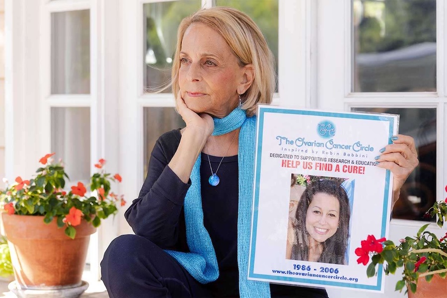 Paulinda Schimmel Babbini holds a sign of her daughter, Robin, calling upon others to join in the fight against ovarian cancer